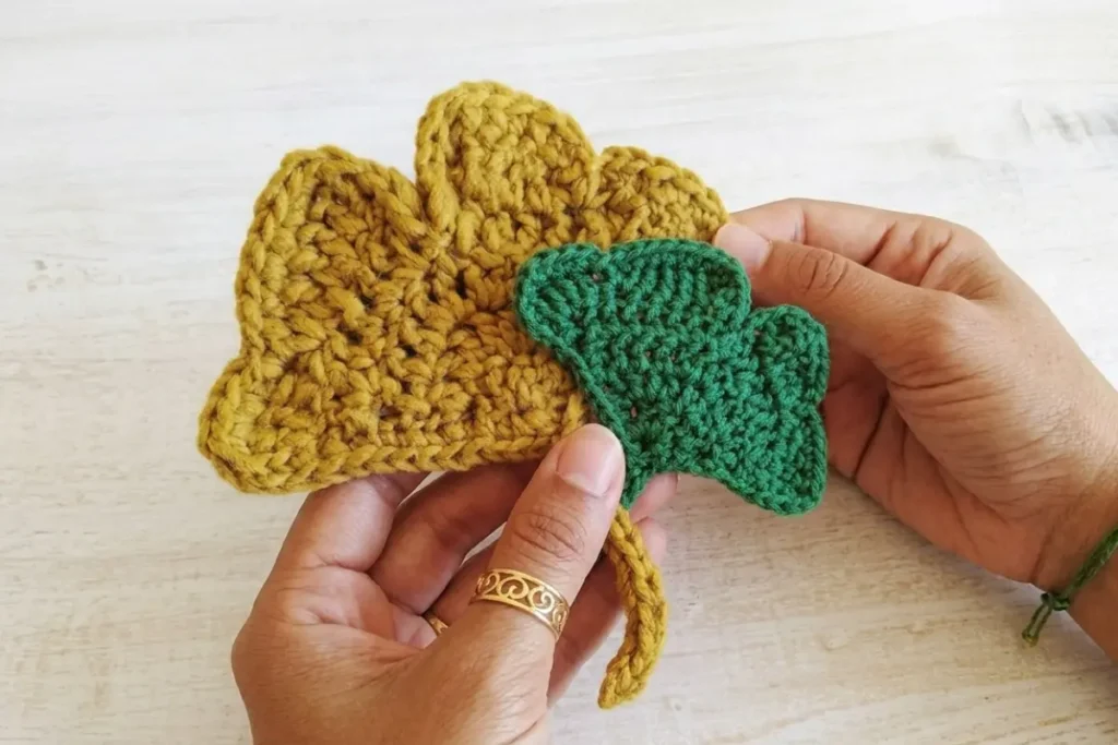 Crochet Ginkgo Leaf Pattern made with green DK cotton yarn and a crochet leaf stem