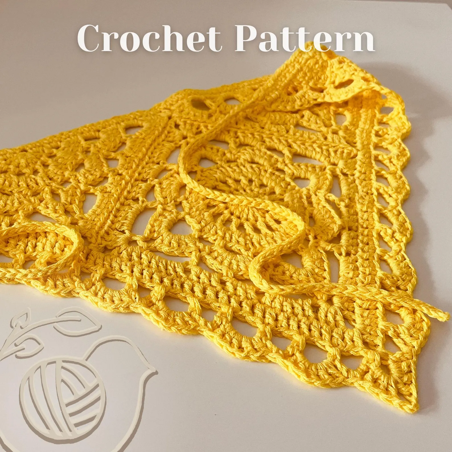 Medium weight yellow yarn and a 4mm crochet hook being used to crochet a beginner granny square bandana.