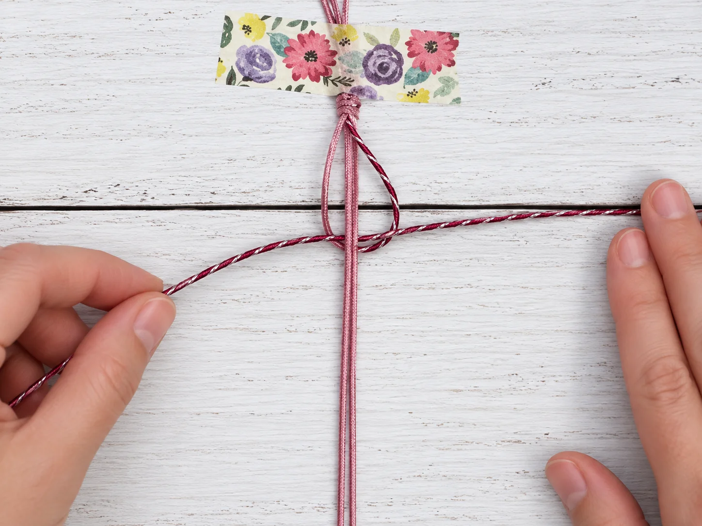 Step 5 passing the left cord behind the center strands and through the right loop