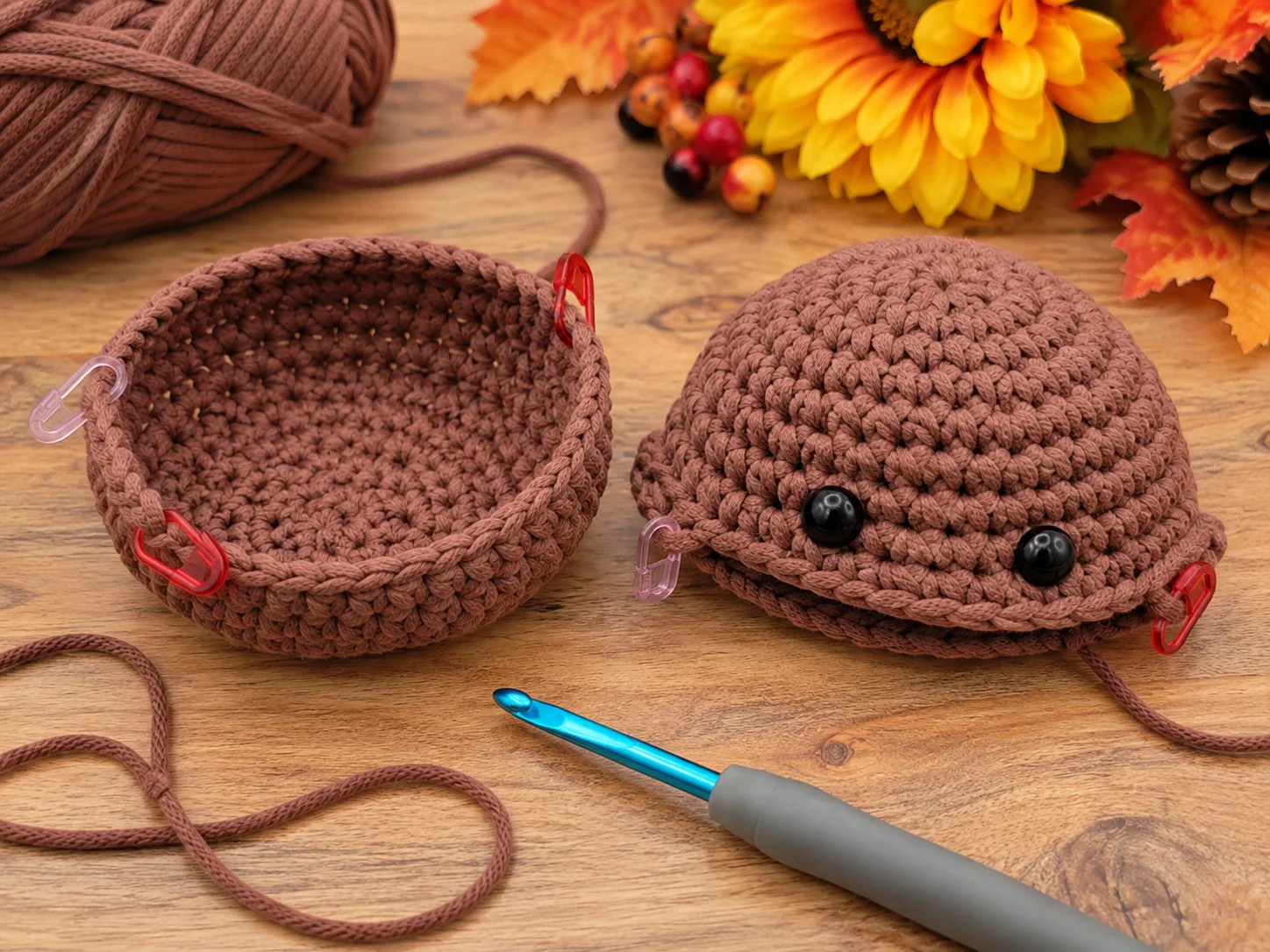 Brown crochet body halves for the Mini Turkey Squish with stitch markers and safety eyes ready for assembly
