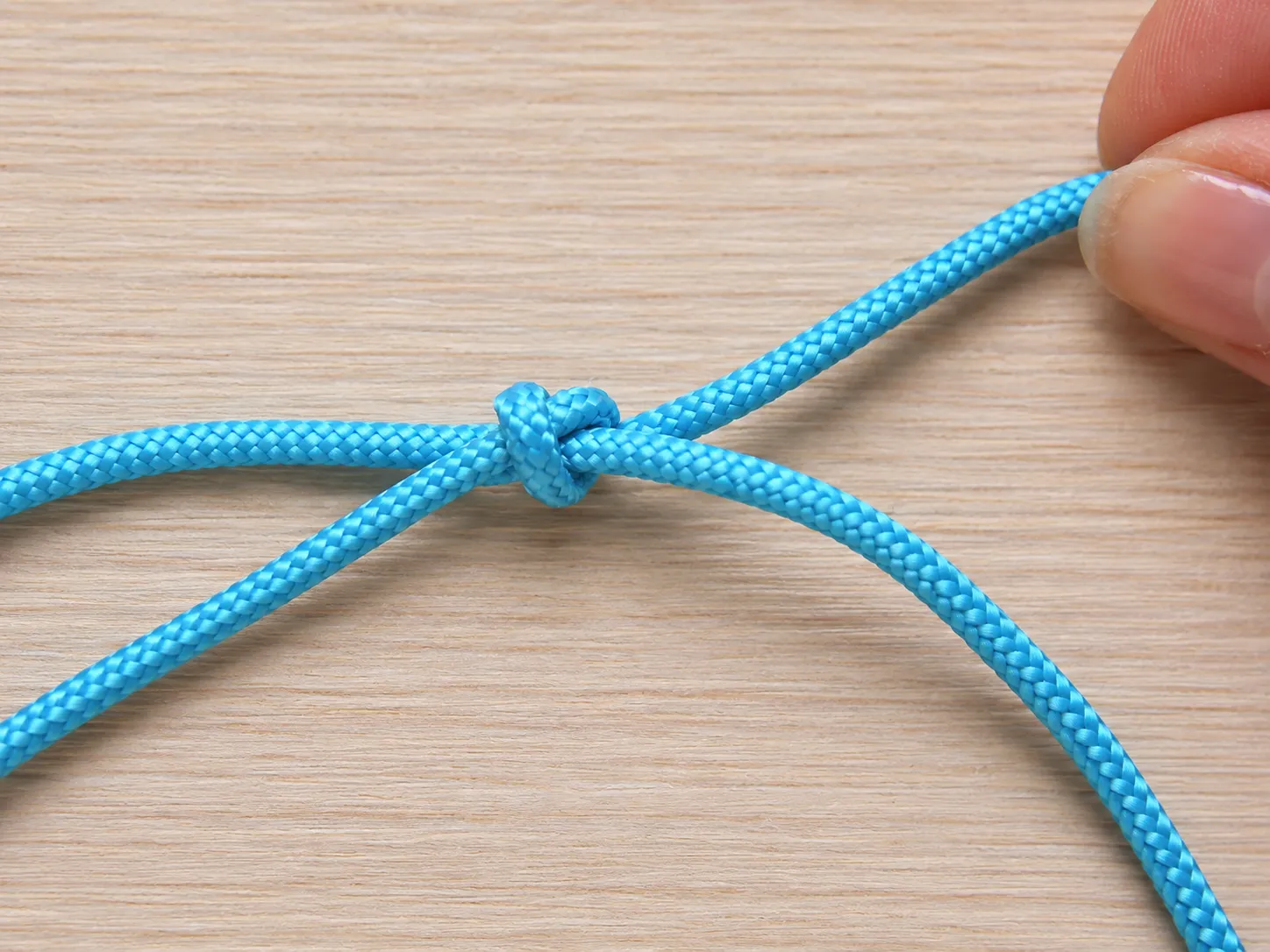Step 4 tightening the first sliding knot while keeping the cord adjustable