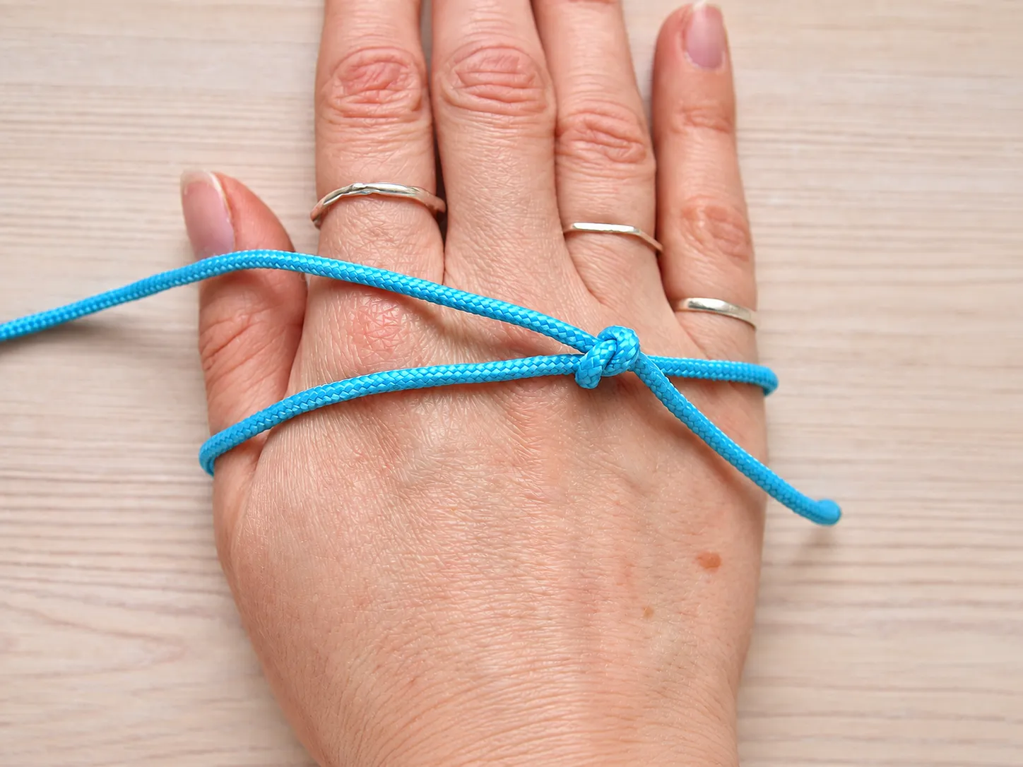 Step 5 checking the sliding knot bracelet size over the widest part of the hand
