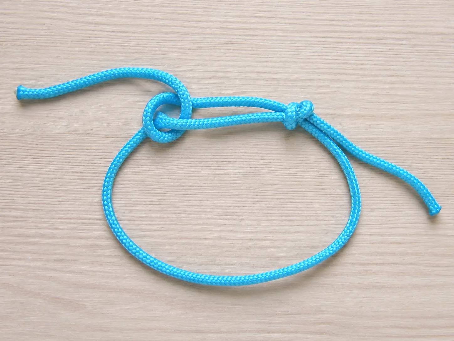 Step 6 forming the second sliding knot on the opposite side of the bracelet