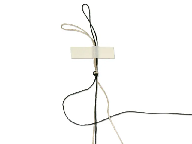 Step 3 crossing the left working cord over the center cords