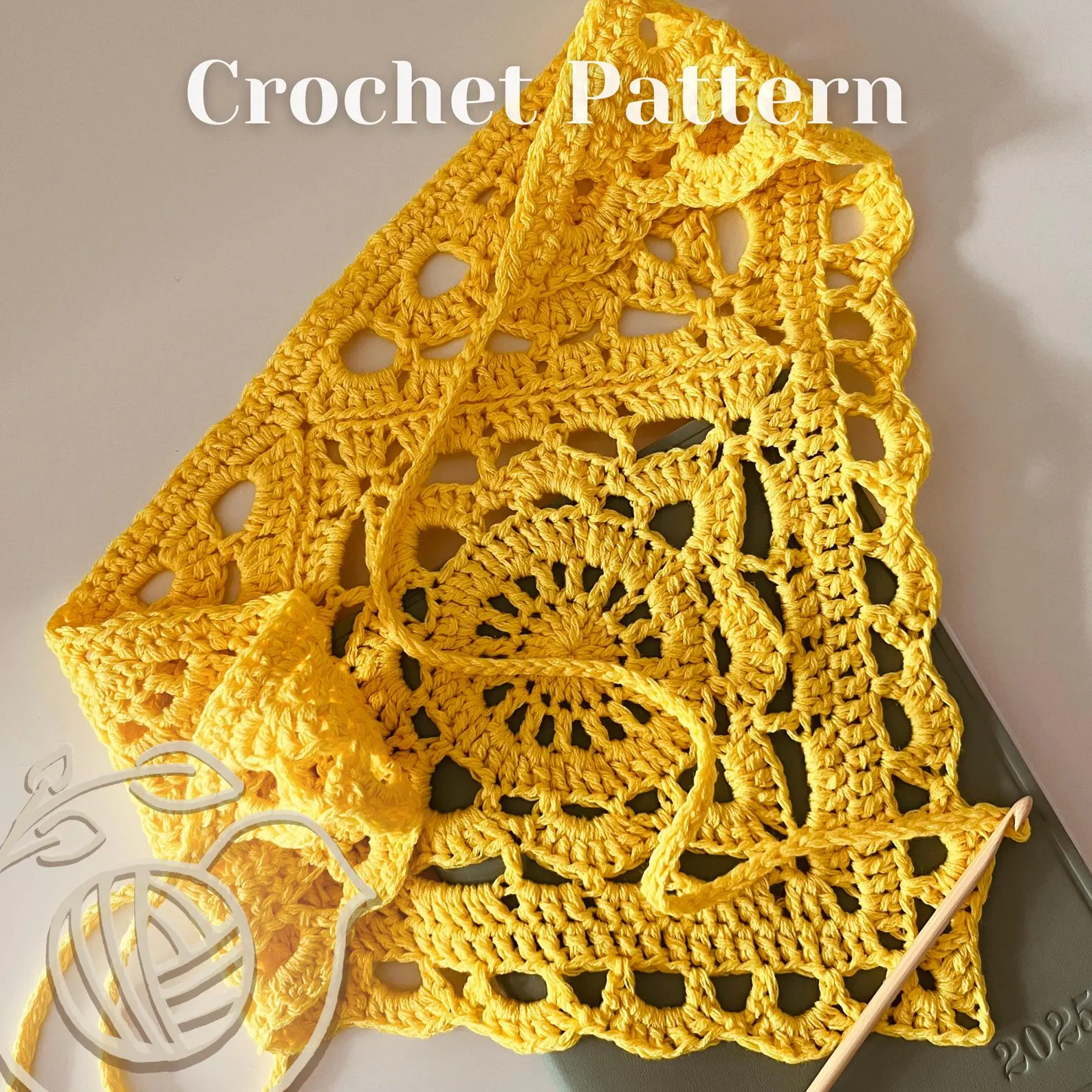 Close up of the delicate floral granny square motif and stitch definition on the yellow crocheted bandana.
