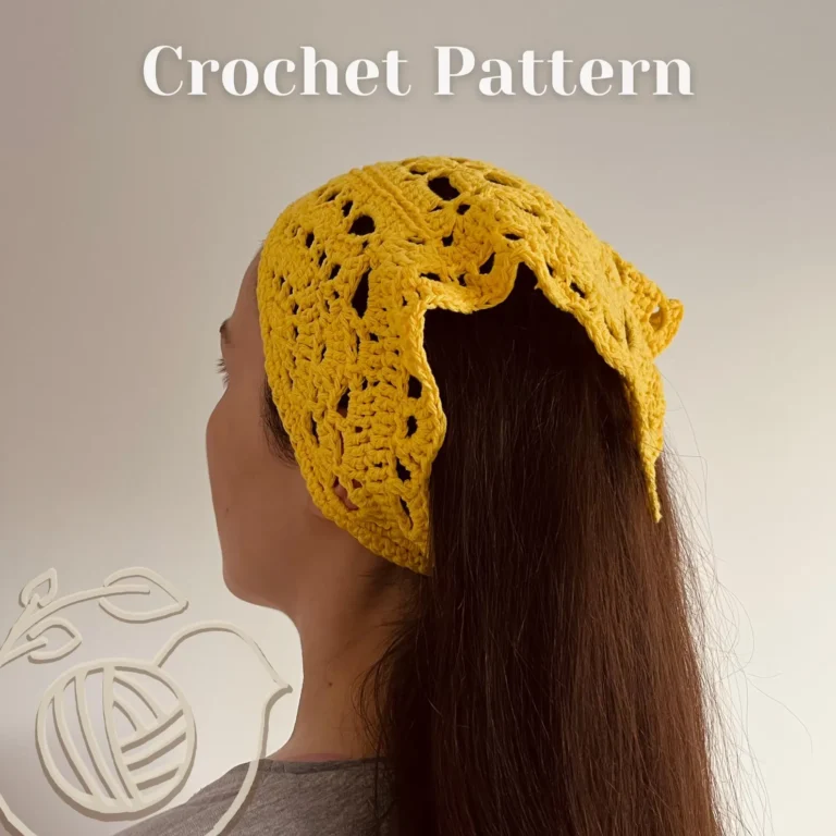 Yellow granny square crochet bandana pattern laid flat showing the complete triangular headscarf design with floral motifs.