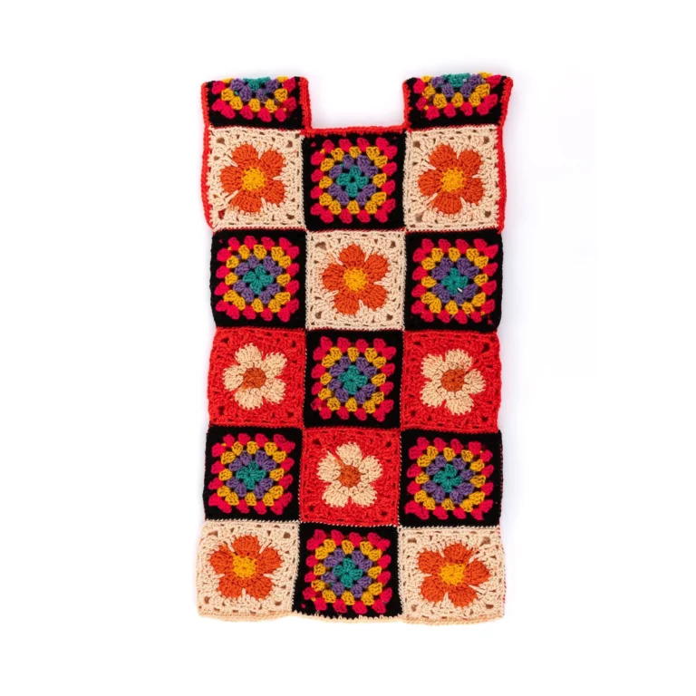 Crochet flower dress showcasing a beautiful floral design made with vibrant yarn.