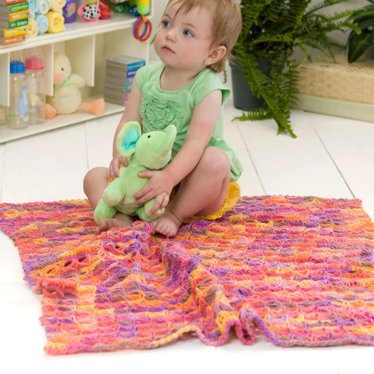 Broomstick Lace crochet baby blanket in soft yarn, showcasing delicate texture.