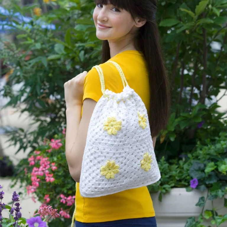 Crochet daisy drawstring bag pattern in vibrant colors
