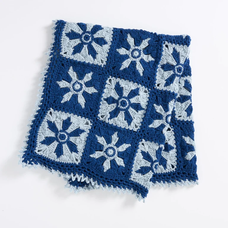 Crochet throw pattern with flying snowflakes design for winter decor
