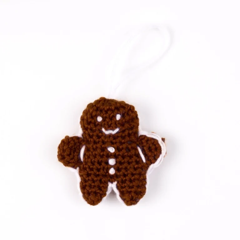 Handmade gingerbread man crochet pattern for advent calendar decoration.