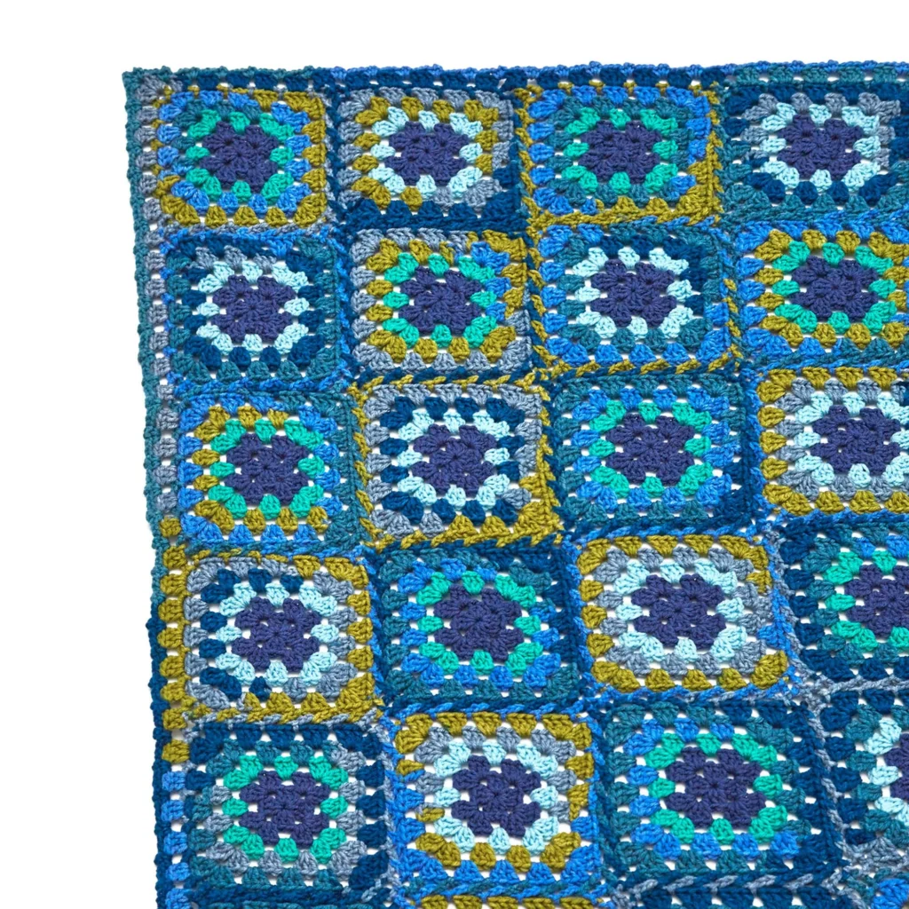 Beautiful granny square crochet throw pattern showcased with colorful squares.