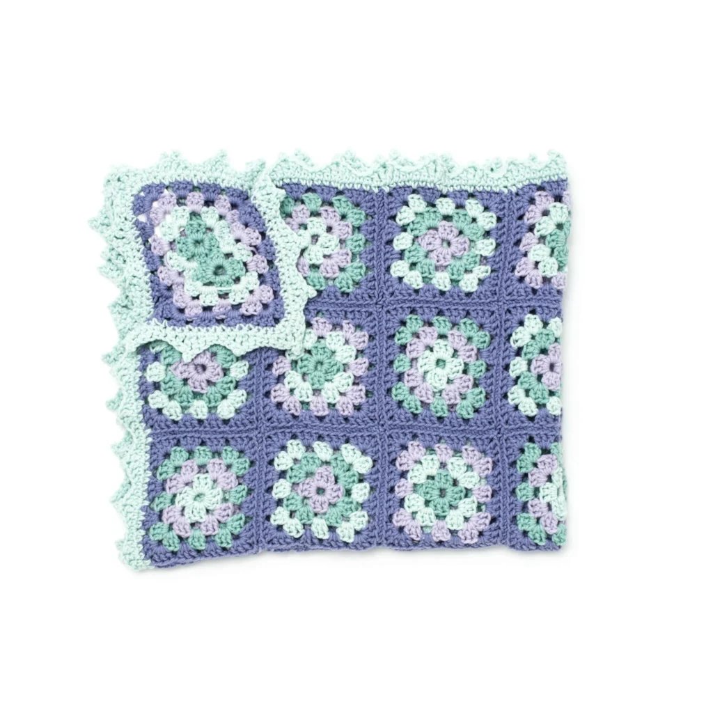 Lullaby Granny Square crochet baby blanket in soft pastel colors.