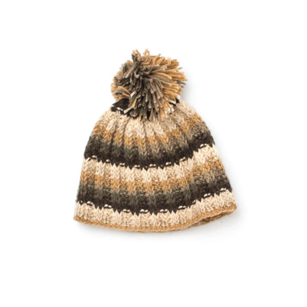 Tunisian Crochet Ribbed Hat Pattern displayed on a wooden table with yarn